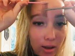 Woman's eyebrow transplant grows so long she has to trim and 'style' them