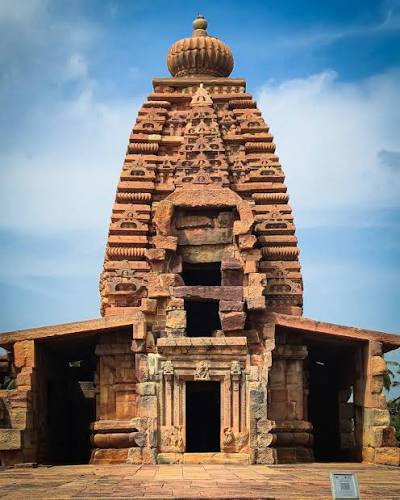 The front view of Mallikarjuna Temple in Pattadakal, also known as Trilokeshwara, shows its partly broken Nandimandapa. Built by Queen Trilokamahadevi around the same time as Virupaksha Temple, it shares similarities but