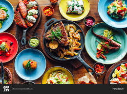 Garnish with parsley and serve with some crusty bread to soak up all those delicious juices. Table Full Of Spanish Cuisine Food Stock Photo Offset