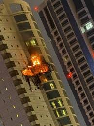 Photos from the scene: flames climb the exterior of The Breaker residential  tower in Bahrain late Saturday following an Iranian attack, with  authorities investigating whether the blaze was caused by a drone