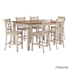 Kitchen tables and more first opened the doors to its columbus, ohio, furniture store in 1979, guided by a vision of creating a place that would be anchored by a literal kitchen table, a furniture piece that we believe unifies a home and creates countless family memories. Elena Antique White Extendable Counter Height Dining Set Double X Back By Inspire Q Classic