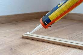 If installing in a wet area, like a bathroom, you should glue the laminate planks to seal the tongue and groove seams from moisture. Glue For Fitting Of Skirting Or Washboard Laminate Floor Renovation Of The House Stock Photo Image Of Flooring Plastic 155355214