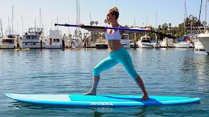 7 Yoga Poses To Do While Stand Up Paddleboarding Paddleboarding Pictures Paddle Boarding Outfit Paddle Boarding