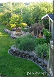 Stacked Pavers Raised Beds And Low Maintenance With The Rock Cover Maybe For The Flowerbeds In The Chi Outdoor Gardens Outdoor Landscaping Patio Garden