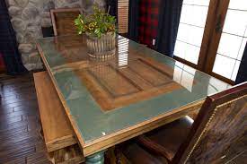 Barn wood decor, decorative ceiling beams, mantels, wide plank. Awesome Table Made Out Of A Repurposed Door In A Ivy League Style Dining Room On Extreme Makeover Lodge Decor Hom Door Dining Table Door Table Rustic House