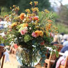 Large Fish Bowl Vase With Beautiful Floral Arrangements At A Wedding Ceremony Flower Centerpieces Wedding Wedding Flowers Fish Bowl Centerpiece Wedding