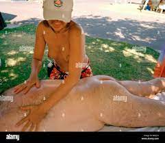 A topless outdoor massage at a nude music festival Stock Photo - Alamy
