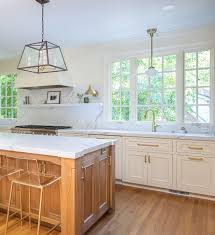 To go contemporary, pair your white cabinets with black hardware. Kitchen Island Maple Kitchen Island With Off White Kitchen Cabinets And White Quartz Countertop Kitchen Isla Kitchen Renovation Small Farmhouse Kitchen Kitchen
