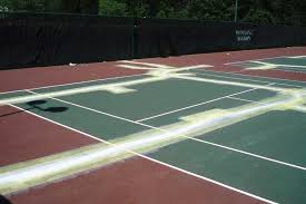 Remove the existing court material is you can or use a grinder to scar up the surface for better adhesion. Resurfacing Southeastern Tennis