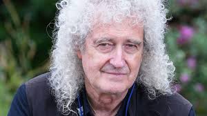 Queen guitarist Sir Brian May plays in pyjamas at Cobham shop