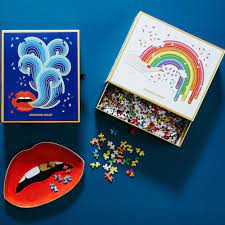 Brighten up game night with the boldest colorway there is: Jonathan Adler Rainbow Hand 750 Piece Shaped Jigsaw Hus Hem