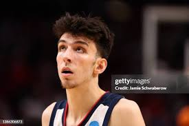 Logan Johnson of the St. Mary's Gaels drives against Parker Stewart... News  Photo