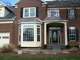 The large amount of windows will provide a panoramic view of the lake, beach, pool, forest, mountain, or river the house is near. Entry Portico And Walk Out Bay Window With Copper Roofs Front Porch Design Portico Entry Porch Design