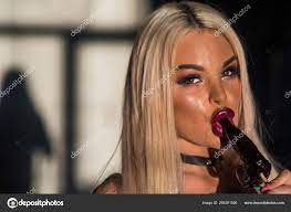 Woman with sensual lips holding dick lollipop. Blonde sucks a lollipop for  adults. Stock Photo by ©inside-studio 266351526