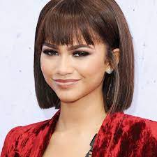 How about going with wavy curls? 9 Celebrities Who Wear Blunt Bangs Really Well