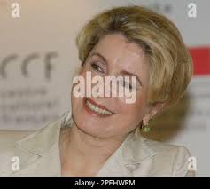 French film star Catherine Deneuve laughs during a news conference,  Tuesday, Nov. 23, 2004, in Jakarta, Indonesia. Deneuve is in Indonesia to  attend a screening of her latest film "Au Plus Pres du Paradis" or "Nearest  to Heaven" also starring William Hurt ...