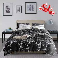 A chic bedroom with a black accent wall, a black stool, rounded nightstands and a fluffy lamp. Wellboo Black Marble Duvet Cover Cotton Queen Full Black And White Bedding Sets Adults Women Men Modern Ceramic Quilt Covers Abstract Organic Crack Artwork Duvet Covers Texture Gothic Chic No Insert