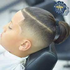 This look can be easily obtained by taking both sides of the girl's hair as if you were forming a ponytail, than pull the hair back and start to braid down the center. Boys Hair Styles