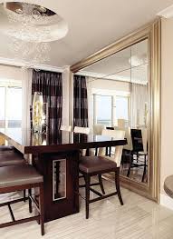 While there are many colors going on here including brown, white, black and touches of red and green (in the area rug), they come together to create a very interesting interior design space. Decorate Using Oversized Mirrors Mirror Dining Room Living Room Mirrors Dining Room Decor