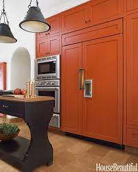 Give kitchen cabinets an inexpensive facelift with a fresh coat of paint. A Bold Burnt Orange Kitchen Burnt Orange Kitchen Kitchen Colors Orange Cabinets