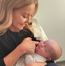 Picture of Kelly and Mark with a precious little one