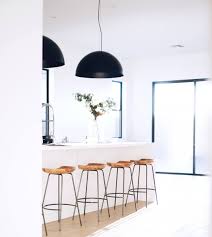 Use the same colour cabinetry for the dining portion of the kitchen island but drop the height by just enough to make it useable as a dining table. Trend Study Oversized Lighting In The Kitchen Dura Supreme Cabinetry