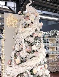First, start with the lights. White Feather Peacock Tree Topper And Garland Taskers Christmas Tree Toppers Rose Gold Christmas Elegant Christmas Trees