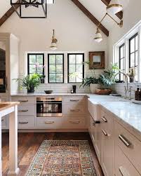 A small white kitchen with sleek cabinets, white stone countertops and a bright green tile backsplash is fun and cool. Beautiful Kitchen Design Ideas To Inspire Your Next Renovation
