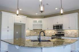 Sometimes having a kitchen island with cooktop can prove to be useful and practical. Beautiful L Shaped Kitchen With White Cabinets Granite Countertops And A Curved Island With L Shaped Kitchen L Shape Kitchen Design Kitchen Island With Sink