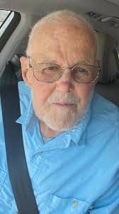 How to edit a photo to remove a seatbelt and make the subject look happier?