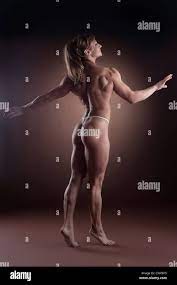 strong woman body builder walk side show naked spine Stock Photo - Alamy