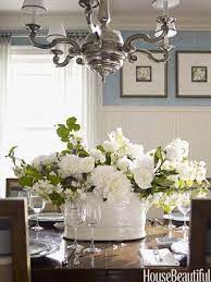 It features blooms that have a light green tint along with wavy, long green leaves, all arranged within a contemporary white vase filled with natural green moss. Beautiful Http Your Flower Arrangement Inspiration Blogspot Com Dining Room Table Centerpieces Dining Room Centerpiece Dining Table Centerpiece