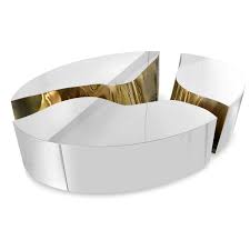This contemporary coffee table boasts a hammered aluminum finish that allows light to bounce off the textured surface. 10 Modern Round Coffee Tables For Your Imposing Living Room