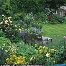 Bench In Walled Corner Of Cottage Garden Informal Beds Of Roses Allium Hardy Geranium Iris Peony Sta Cottage Garden Rose Garden Design Garden Inspiration