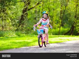 Using a balance bike instead of a bicycle with training wheels. Child On Bike Kids Image Photo Free Trial Bigstock
