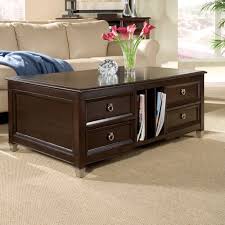 A black metal frame adds style and durability to this coffee table with a lift top. Darien Transitional Burnt Umber Rectangular Lift Top Coffee Table With Casters Today