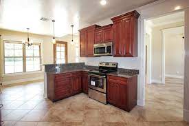 The more detailed door style, a more detailed crown would be appropriate. Cherry Maple Kitchen With Different Wall Height Cabinets How To Crown Molding On Different Wal Simple Kitchen Design Kitchen Cabinets Simple Kitchen Cabinets