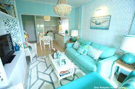 Coastal Inspired Beach House Seaside Inspired Turquoise Blue Aqua Blue Turquoise Sofa Condo Interior Design Small Condo Interior Design Small Living Rooms