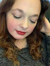 Soft glam makeup look with glossy lips and matte wings