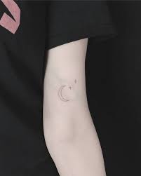 Simplistic depictions of a crescent moon and sun are rendered in the center of the wearer's back in this tattoo set. Delicate Moon Stars Small Moon Tattoos Moon Star Tattoo Star Tattoos