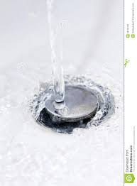 water running down a bathroom sink plug