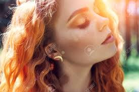 In such a case one can only notice the blue in the eyes once sun or bright light is reflected in the eyes, therefore, the eyes seem dull and uncannily dark compared to the true blue color. Beautiful Redhead Norwegian Girl With Big Eyes And Freckles On Face In The Forest Portrait Of