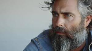 Contemplative Bearded Man Gazes Thoughtfully Out Over Rolling Hills During  Golden Hour Sunlight 48816915 Stock Photo at Vecteezy