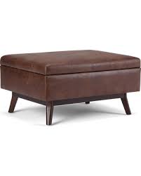 The ottoman features a sleek rectangular shape that is softened by black faux leather upholstery. 20 Off 34 Ethan Coffee Table Storage Ottoman Distressed Saddle Brown Wyndenhall