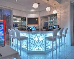 Awesome Modern Home Bar With Glowy Table And Fancy Bar Stools Design At Red South Beach Hotel Contemporary Family Rooms Modern Home Bar Bars For Home