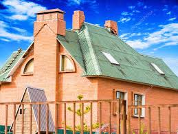 This lateral gabled bungalow with jerkinhead roof form and horizontal expression, is wood framed with brick foundation and stucco veneer. Chimney On The Roof Of The House Against The Blue Sky 71324979 Larastock
