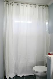 Definitely shower curtains, it's much easier on tenants to change liners than having to scrub shower doors. How To Hang Double Shower Curtains For Less Thrifty Decor Chick