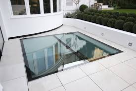 External View Of Walk On Glass Floor Above Basement Renovation Www Iqglassuk Com Glass Floor Glass Roof Roof Design