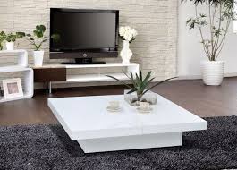 Albano coffee table a molded white cube table with a glass center shelf gives your living room a sleek, modern look. Table Basse Blanche Pour Salon En 20 Exemples Magnifiques White Coffee Table Modern White Living Room Tables Coffee Table Square