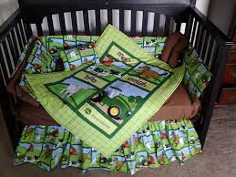 Fitted crib sheet displaying jd tractors, logos and farm animals on a white background. Pin On Itty Bitty Baby